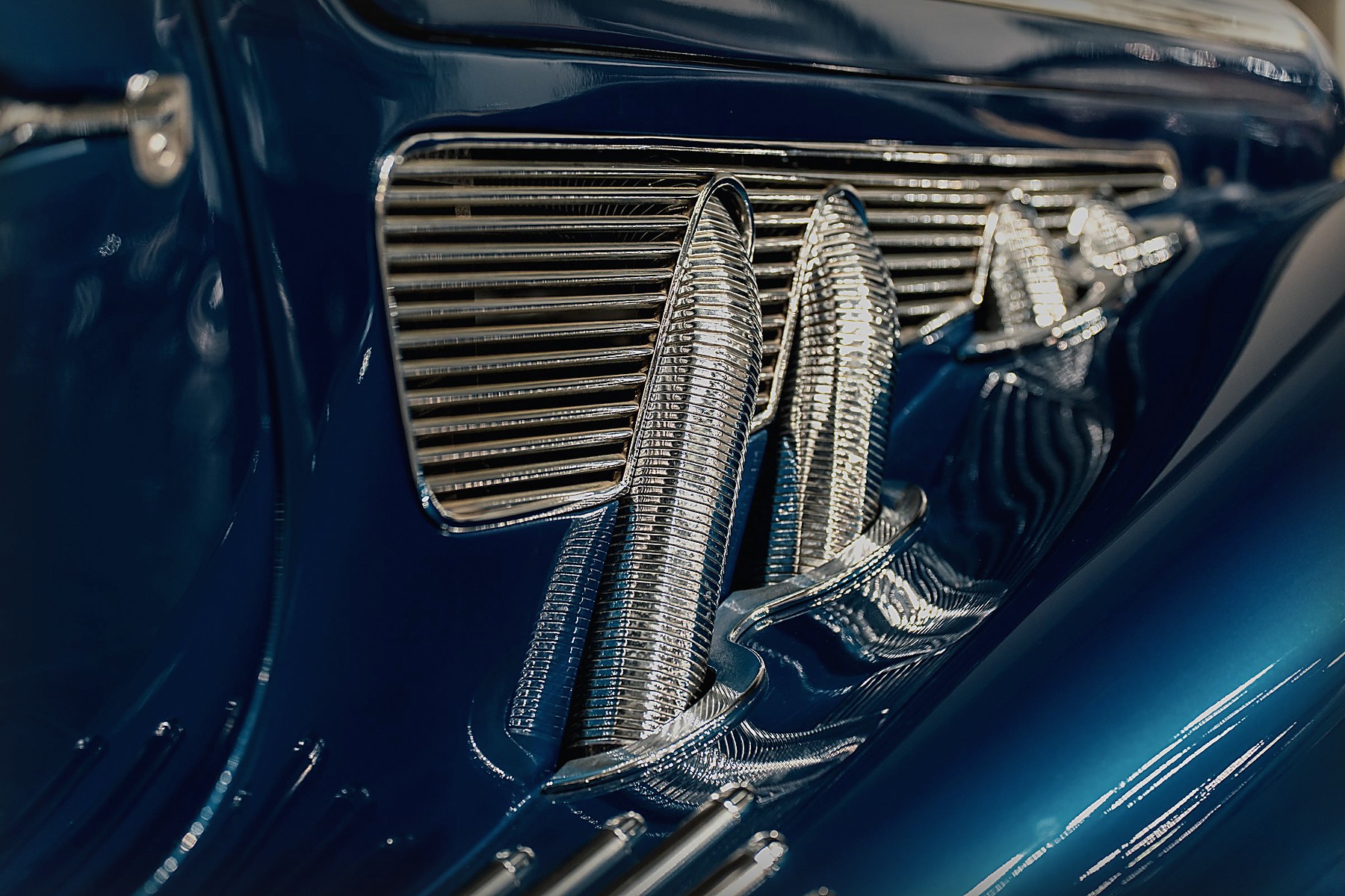 Close view of chrome trim and bodywork on a classic car