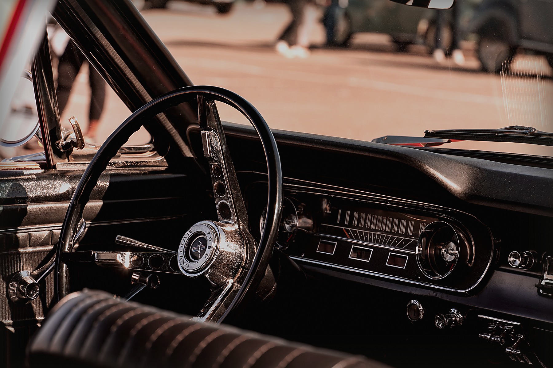Retro steering wheel and dashboard inside a classic car