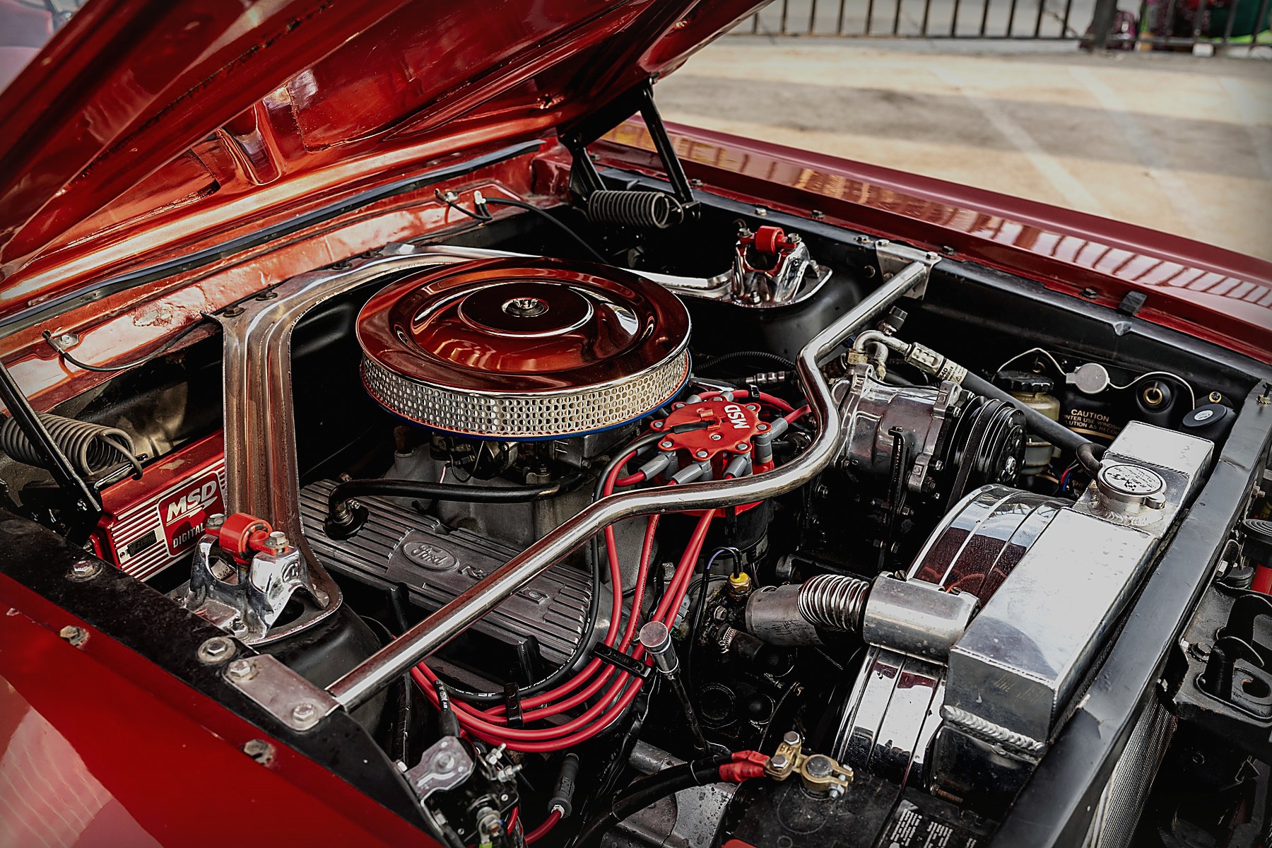 Engine and components beneath an open vehicle bonnet