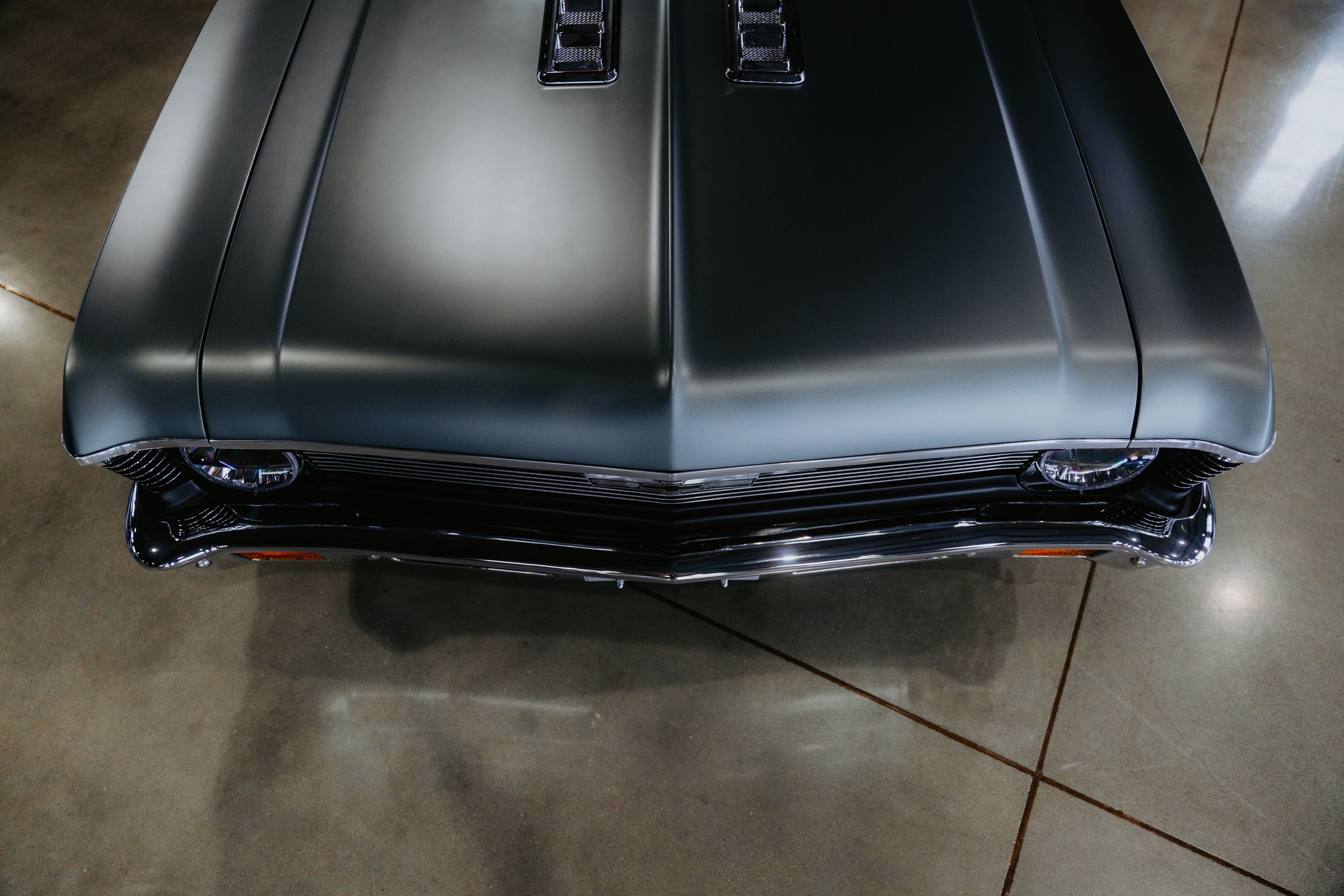Front view of a classic muscle car in a garage