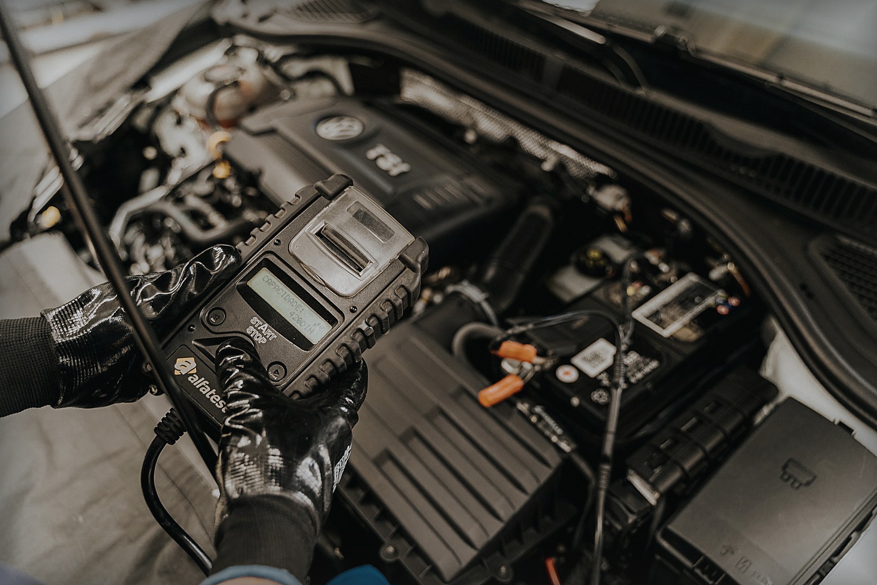 Mechanic inspecting a modern car engine bay