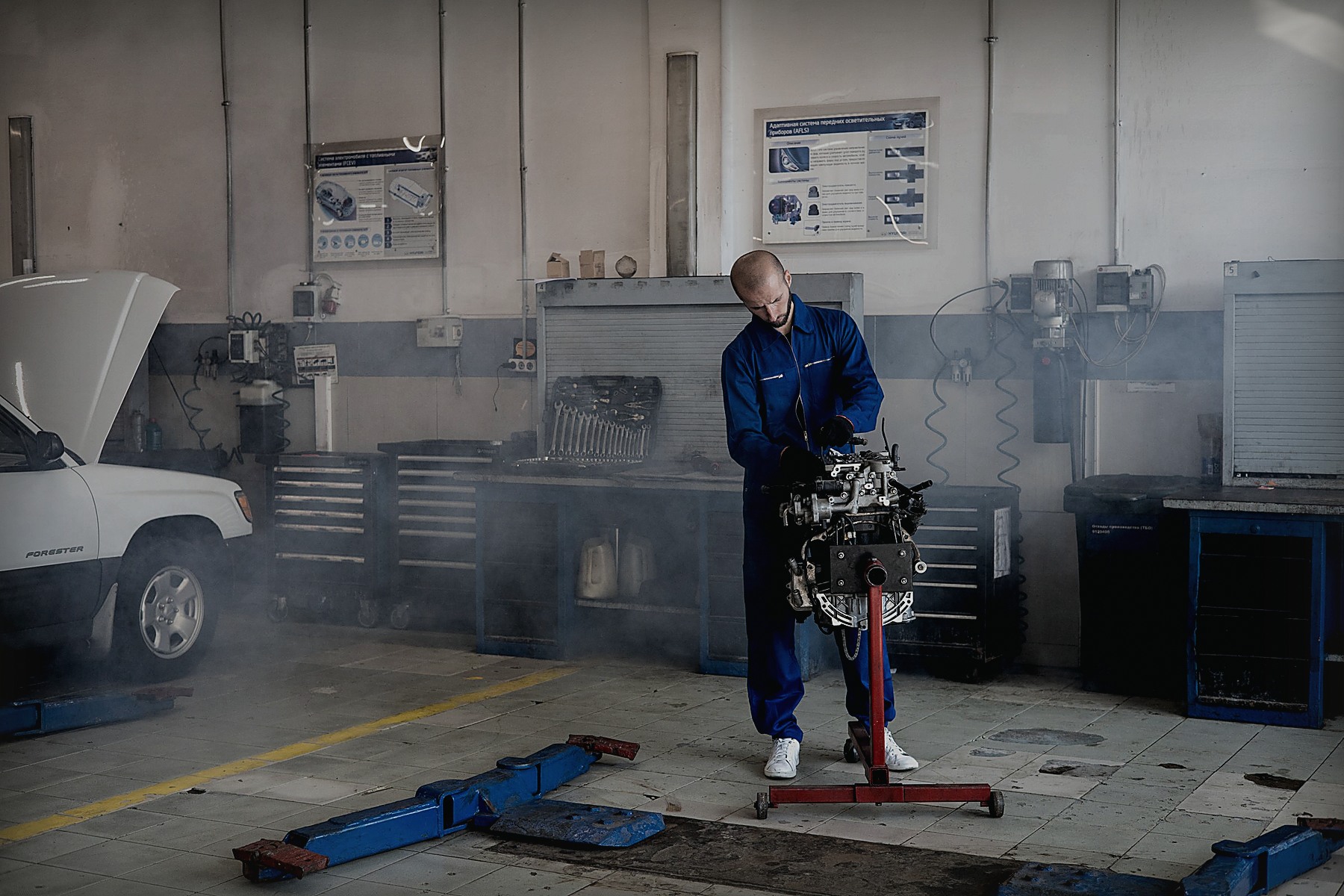 Mechanic working on a vehicle inside an automotive workshop